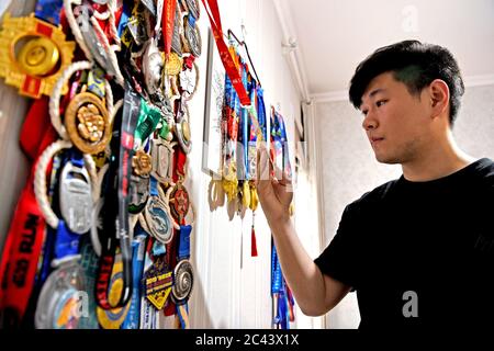 Huainan, Huainan, Chine. 24 juin 2020. Anhuià¯ÂμÅ'CHINA-He Shuai montre 61 MÉDAILLES de marathon et des certificats remportés par son père He Ming, un combattant du cancer, dans la ville de Huainan, province d'Anhui en Chine orientale, le 18 juin 2020. Il a dit qu'il voulait s'entraîner à partir de maintenant et finir 100 marathons pour son père.le 14 avril 2016, il s'est rendu à l'hôpital pour faire un contrôle et a été diagnostiqué avec un cancer du poumon avancé en raison de toux fréquente. Le médecin a dit qu'il avait moins de trois mois pour vivre. Après plus de 30 traitements de chimiothérapie, son fort désir de vivre et de forte volonté le maintenir pendant neuf mois. AF Banque D'Images