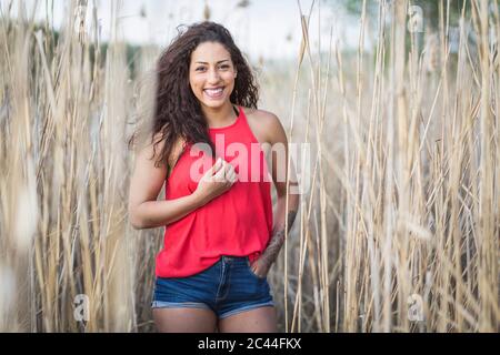 Portrait de la jeune femme debout au milieu du roseau Banque D'Images