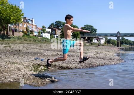 Météo Royaume-Uni : Londres, Royaume-Uni. 24 juin 2020. Après-midi chaud et ensoleillé à Chiswick. Un groupe de garçons se rafraîchissez en sautant sur la Tamise. Crédit : Liam Asman/Alay Live News Banque D'Images