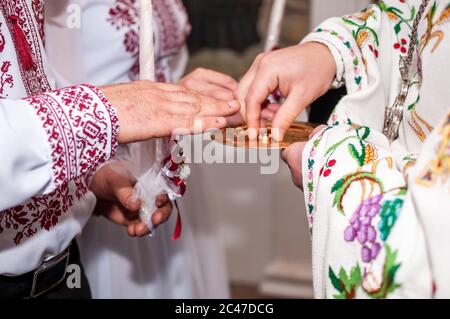 Le prêtre habille les anneaux de mariage sur le doigt Banque D'Images