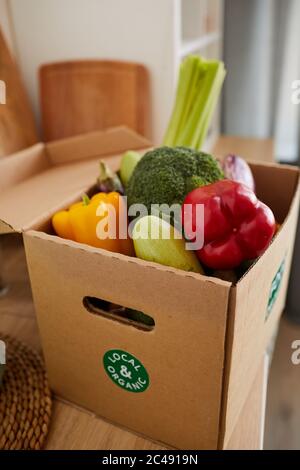Gros plan de la boîte en carton contenant les légumes frais sur la table à livrer à la maison Banque D'Images