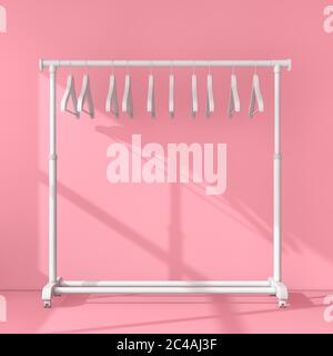 Présentoir mobile blanc pour manteaux avec cintres dans la salle rose. Rendu 3d Banque D'Images
