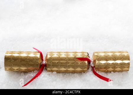 Papillote de Noël dorée dans la neige avec espace pour copier votre propre message Banque D'Images