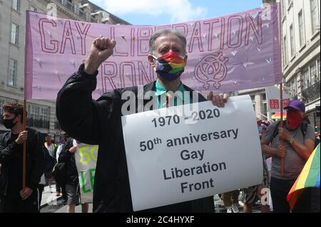 Peter Tatchell (au centre) mène une marche à travers Londres pour marquer le 50e anniversaire du Front de libération gay de Londres. Banque D'Images