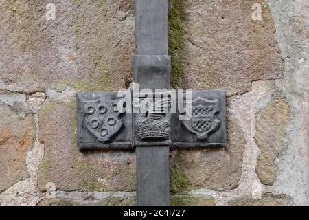 Vue détaillée d'une gouttière médiévale au plomb vue à l'extérieur d'un bâtiment historique. Les armoiries sont clairement visibles sur le fil. Banque D'Images