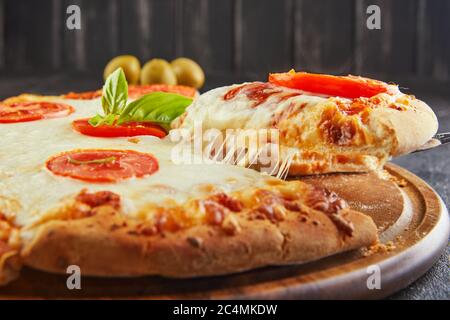 Le goût délicieux de pizza et de tranches de fromage avec mozzarella et tomates. Pizza triangle avec fromage et épices. Copier l'espace pour le texte. Banque D'Images