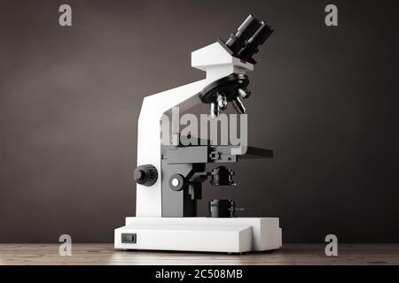 Microscope de laboratoire moderne sur une table en bois. Rendu 3d. Banque D'Images