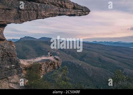 Woman est assise sur les balcons et regarde le paysage du parc national des Grampians, Victoria, Australie Banque D'Images