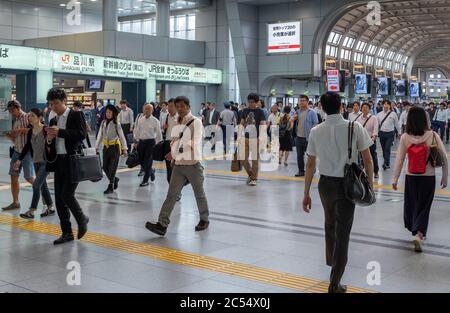 Salaryman travailleur de bureau des navetteurs marchant à la gare de Shinawaga, Tokyo, pendant les heures de pointe du matin. Banque D'Images