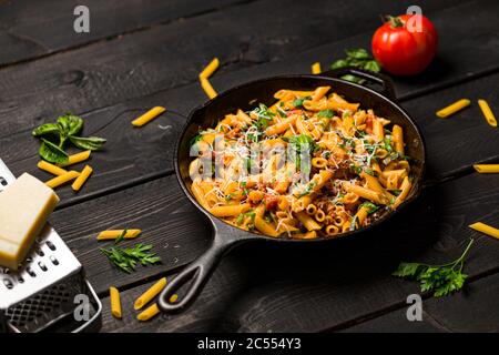 Pâtes Penne dans une poêle. Ce repas de pâtes rapide et délicieux est composé de pâtes de penne, de sauce tomate fraîche et de saucisses. Cette cuisine italienne de confort Banque D'Images