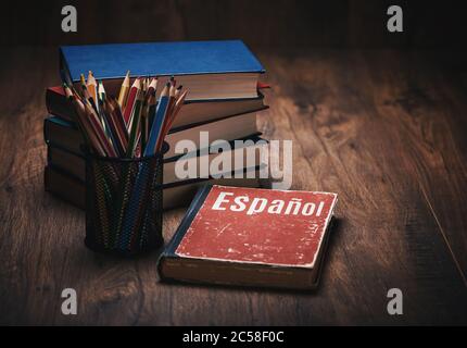 Apprendre l'espagnol. Livre sur fond de table en bois Banque D'Images