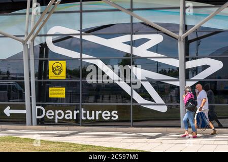 Premier vol passager depuis l'aéroport Southend de Londres, Essex, Royaume-Uni, après le verrouillage du coronavirus COVID-19. Personnes arrivant au terminal des départs. Masques Banque D'Images