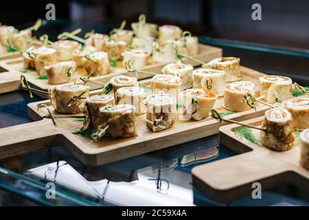 Rouleaux de viande sur une planche à découper sur une table en verre Banque D'Images