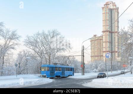 Moscou après la chute de neige en hiver, Russie. Le tramway circule sur la neige couverte de la rue. Froid et gel à Moscou. Vue panoramique sur la ville enneigée. Le transport urbain fonctionne Banque D'Images