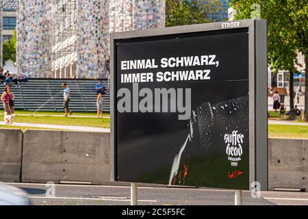 Publicité pour une bière noire devant Parthenen of Books à Documenta 2017 à Kassel, Allemagne. L'artiste argentin Marta Minujin a érigé d'innombrables livres sur un Parthénon sur un échafaudage Banque D'Images