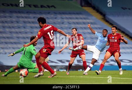 Raheem Sterling de Manchester City tire et Alex Oxlade-Chamberlain de Liverpool place le ballon dans son propre but pour le quatrième but de Manchester City lors du match de la Premier League au Etihad Stadium de Manchester. Banque D'Images