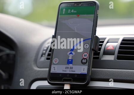 smartphone avec carte de navigation sur le tableau de bord en voiture, gros plan de la navigation avec une application gps Banque D'Images