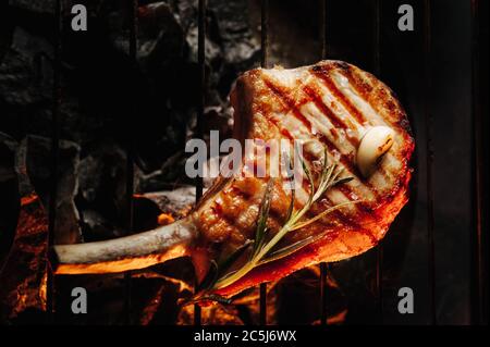 steak frit sur l'os avec du romarin et de l'ail grillé, steak de garchi avec une vue fumée du dessus Banque D'Images