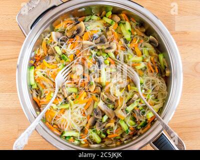 Fjunchoza aux champignons et aux légumes. Ingrédients mélangés dans une casserole, vue de dessus. Banque D'Images