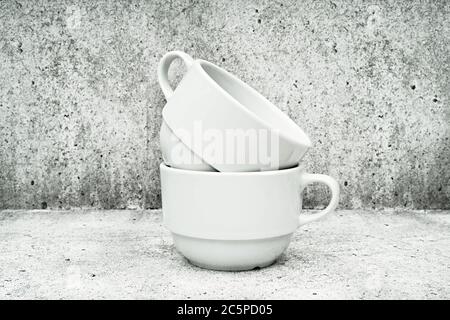 Deux tasses blanches sur fond clair. Plats pour café. Tasse à café. Banque D'Images