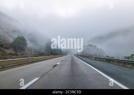 Route à brouillard de brouillard route conduite point de vue de pov dans la campagne rurale en Virginie occidentale à travers les nuages gris sur la voie pavée raide Banque D'Images