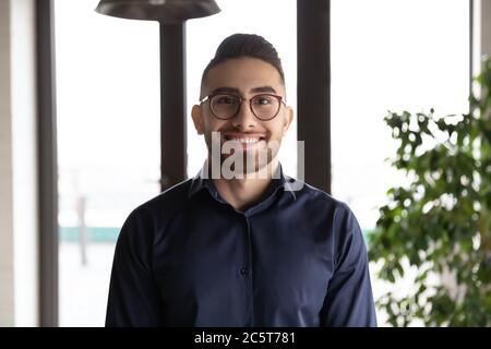 Portrait en tête d'un homme arabe souriant employé en lunettes Banque D'Images