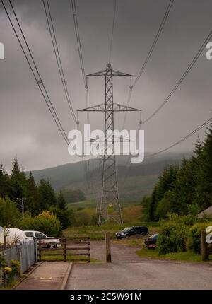 Dalmally, Écosse, Royaume-Uni - 4 juin 2011 : les lignes électriques haute tension traversent les landes sur un flanc de montagne près de Dalmally dans les West Highlands de Scotlan Banque D'Images