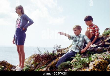 Famille sur la falaise promenade avec trois enfants, une adolescente blonde et deux jeunes garçons lors d'une journée ensoleillée d'été à Cornwall, Royaume-Uni dans les années 1960, lors d'un séjour d'été Banque D'Images