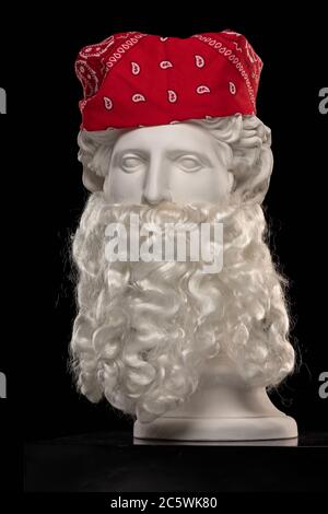 Statue en plâtre blanc d'un buste d'Apollo Belvedere avec une longue barbe blanche et un foulard de bandana rouge Banque D'Images