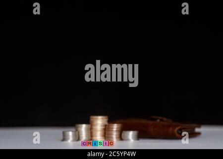 Pile de pièces avec un symbole de croissance en échelle fond gris avec inscription de billets cubes colorés de crise. Banque D'Images