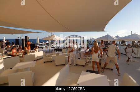 Palma, Espagne. 23 juin 2020. Les clients sont au coucher du soleil dans le bar Purobeach à Cala Estancia sur la plage Playa de Palma. Credit: Clara Margais/dpa/Alay Live News Banque D'Images