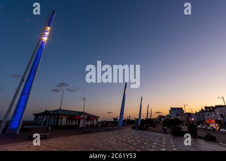 Tours lumineuses sur City Beach, Southend on Sea, Essex, Royaume-Uni, illuminées en bleu pour honorer le 72e anniversaire du NHS. Service national de santé. Coucher de soleil crépuscule Banque D'Images