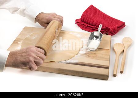 un boulanger utilisant une goupille en bois pour faire rouler un morceau de pâte à tarte isolé sur blanc Banque D'Images