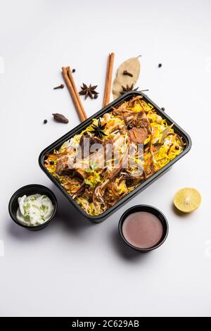 Style restaurant Gocht ou Mutton Biryani ou Pulao emballé pour livraison à domicile dans une boîte en plastique ou un contenant avec Raita et salan Banque D'Images