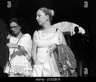 Monténégro, 22 septembre 2019 : deux femmes passant une entrée en arche de la vieille ville de Kotor (B/W) Banque D'Images