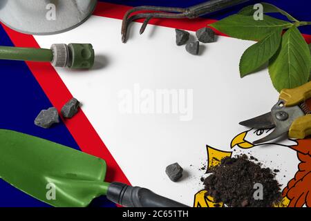 Drapeau des Samoa américaines avec outils de jardinage fond sur la table. Concept de printemps dans le jardin avec espace de copie gratuit. Banque D'Images