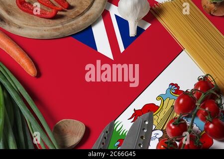 Drapeau des Bermudes sur les légumes frais et le concept de couteau table en bois. Concept de cuisine avec thème de préparation. Banque D'Images