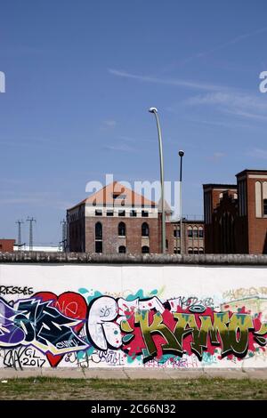 L'arrière de la galerie East Side d'un mur peint avec des graffitis colorés dans le quartier berlinois de Friedrichshain à Berlin, Banque D'Images