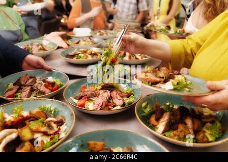 Personnes dînant à un banquet, pas de visages visibles, tonifiée Banque D'Images