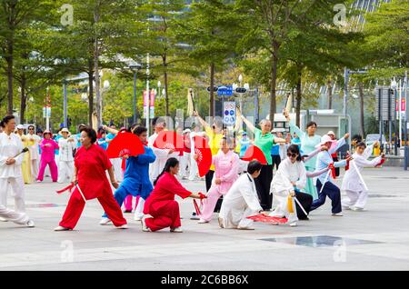 Shenzhen, Chine - 14 novembre 2015 : un groupe de retraités pratiquent la danse d'art martial dans la rue. C'est une sp. Traditionnelle et populaire Banque D'Images