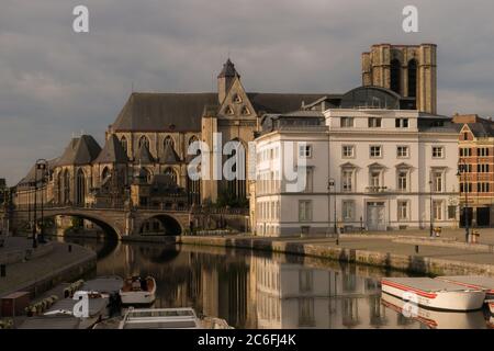 Gand, Belgique - 10 juin 2019 : une agréable vue matinale de la vieille ville médiévale de Gand, le long de la rivière Leie, jusqu'à l'église Saint-Michel. Banque D'Images