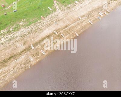 Bateaux sur la rive rocheuse de la rivière. Port de plaisance du village Banque D'Images