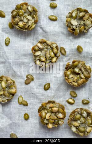 Bonbons bio faits de graines de citrouille. Biscuits de fitness sur fond de lin. Gros plan. Vue de dessus Banque D'Images