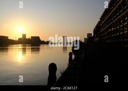 Silhouette de bâtiments modernes sur la rivière IJ en été juste avant le coucher du soleil à Amsterdam, aux pays-Bas Banque D'Images