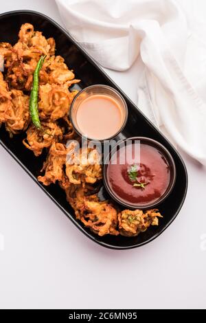 Pakora à l'oignon frit ou Pyaj Pakoda également connu sous le nom de Crispy Kanda bhaji /Bhajji / bajji, encas indien préféré pendant la saison des pluies. Servi wi Banque D'Images