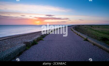 Le mur de la mer du Nord au lever du soleil qui longe la côte nord du Kent entre Reculver et la baie de Minnis. Banque D'Images
