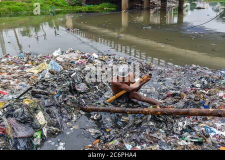 Dhaka, Bangladesh. 11 juillet 2020. Un volontaire nettoie la rive entourant le canal.c'était un canal avant mais le dépôt continu de déchets urbains en fait un terrain à Savar. Crédit : SOPA Images Limited/Alamy Live News Banque D'Images