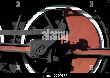 gros plan d'une ancienne roue de locomotive à vapeur peinte en rouge avec garniture noire et blanche Banque D'Images