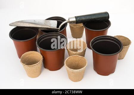 Un studio Photographie d'une truelle de jardin, pots de plantes en plastique rouge et pots de plantes en fibre biodégradable Banque D'Images