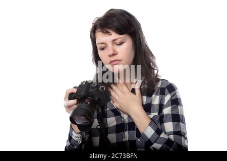 Jeune femme photographe professionnel indépendant, étudiante en art ou photojournaliste sur fond blanc tenant un appareil photo. Elle se sent malade ou pas Banque D'Images